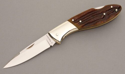Jim Thompson Lockback with Amber Jigged Bone handle material - Obverse Side - Item #KLC08275