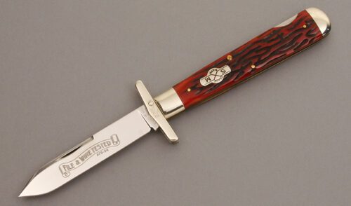 Schatt & Morgan Swing Guard Lockback with Red Worm Groove Jigged Bone handle material - Obverse Side - Item #KLC08494