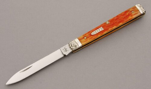 Case/Brian Yellowhorse 6185 Dr. Knife with Orange Jigged Bone handle material - Obverse Side - Item #KLC08714