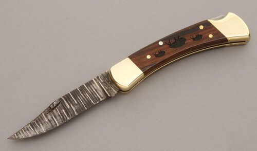 Buck Knives 110 Walking Buffalo Lockback with Macassar Ebony Wood Micarta handle material - Obverse Side - Item #KLC08723