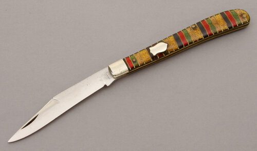 U.K.& R. Co. Slim Serpentine Folder with Christmas Candy Celluloid handle material - Obverse Side - Item #KLC10282
