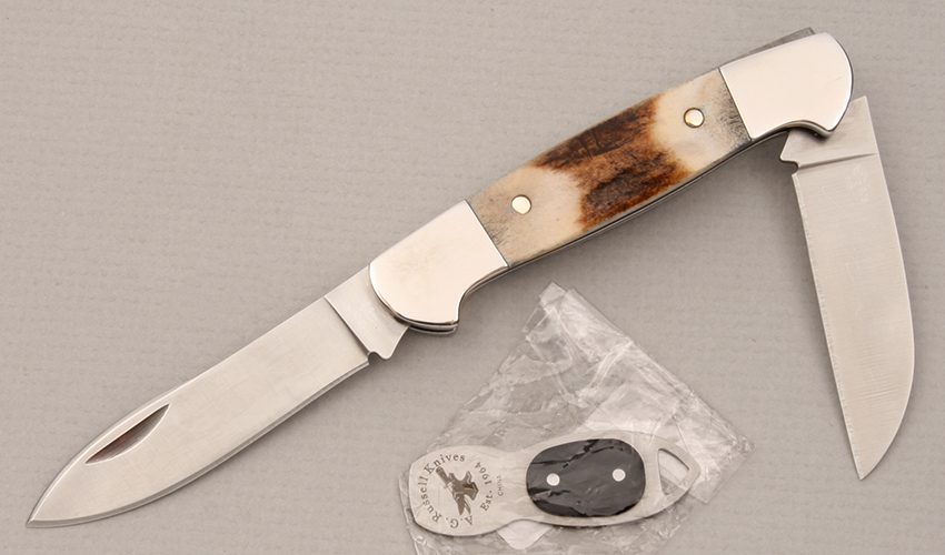Buck Knives Buck/Russell Signature Knife with India Stag Scales handle material - Obverse Side - Item #KLC14469