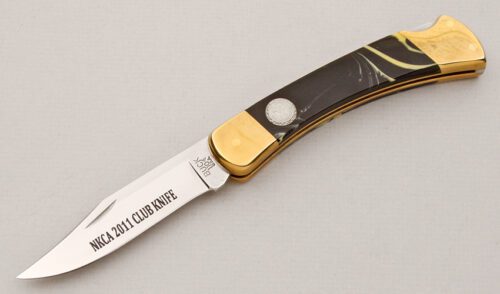Buck Knives 110 NKCA 2011 Lockback with Black/Yellow Composition handle material - Obverse Side - Item #KLC15017